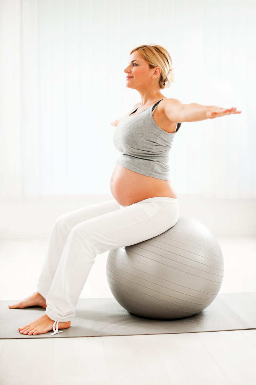 Beautiful pregnant woman doing exercises – Barbican Physio