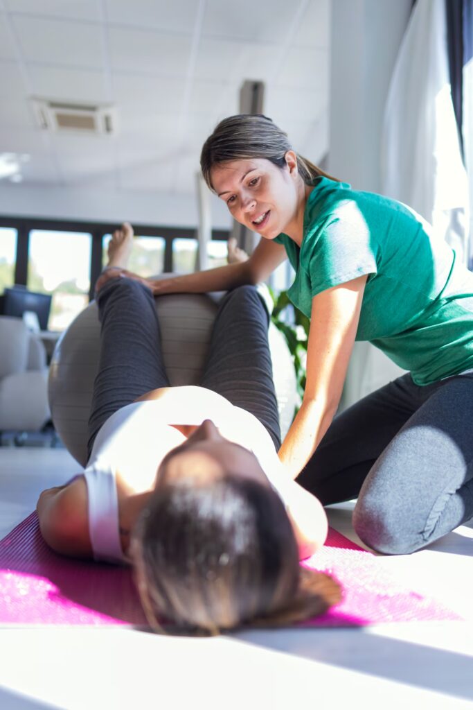 Women's Health 1 physiotherapist helping to beautiful pregnant woma 2024 09 12 18 24 08 utc